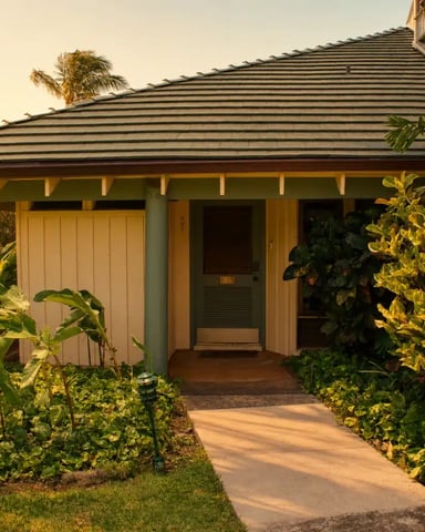 Single-story tropical home with metal roof, covered porch, and lush green landscaping along pathway